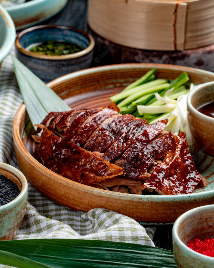 Gourmet Roasted Peking Duck On Curved Wooden Plate Wallpaper