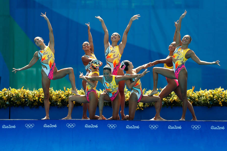 Graceful Synchronized Swimming At The Summer Olympics Wallpaper