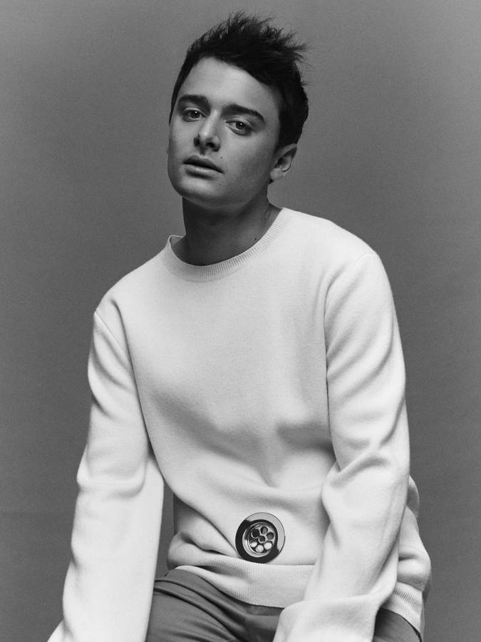 Grayscale Noah Schnapp In White Sweater Wallpaper