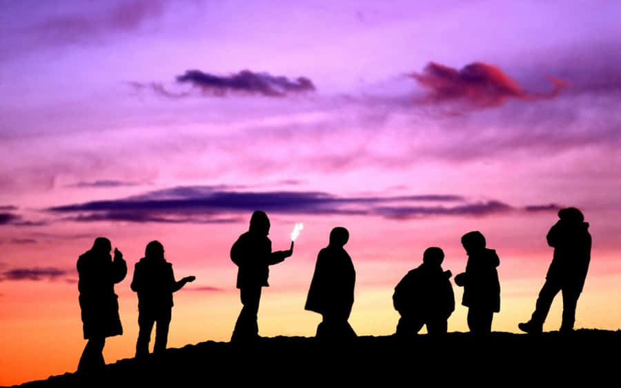 Group Of Friends With Colorful Skies Wallpaper