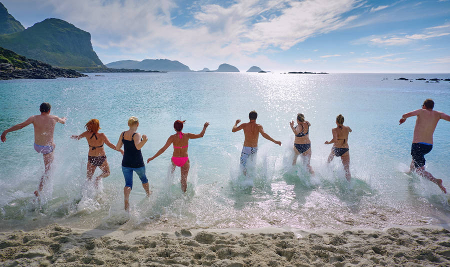 Group Of People Running To The Water Wallpaper