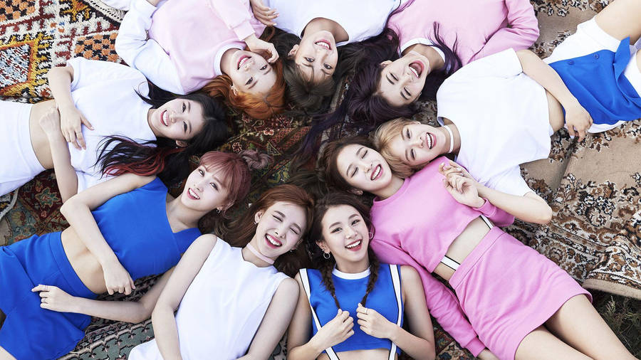 Group Twice Lying On Carpet Wallpaper