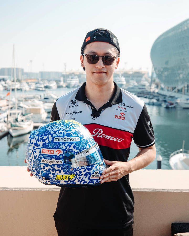 Guanyu Zhou Holding His Race Helmet Wallpaper