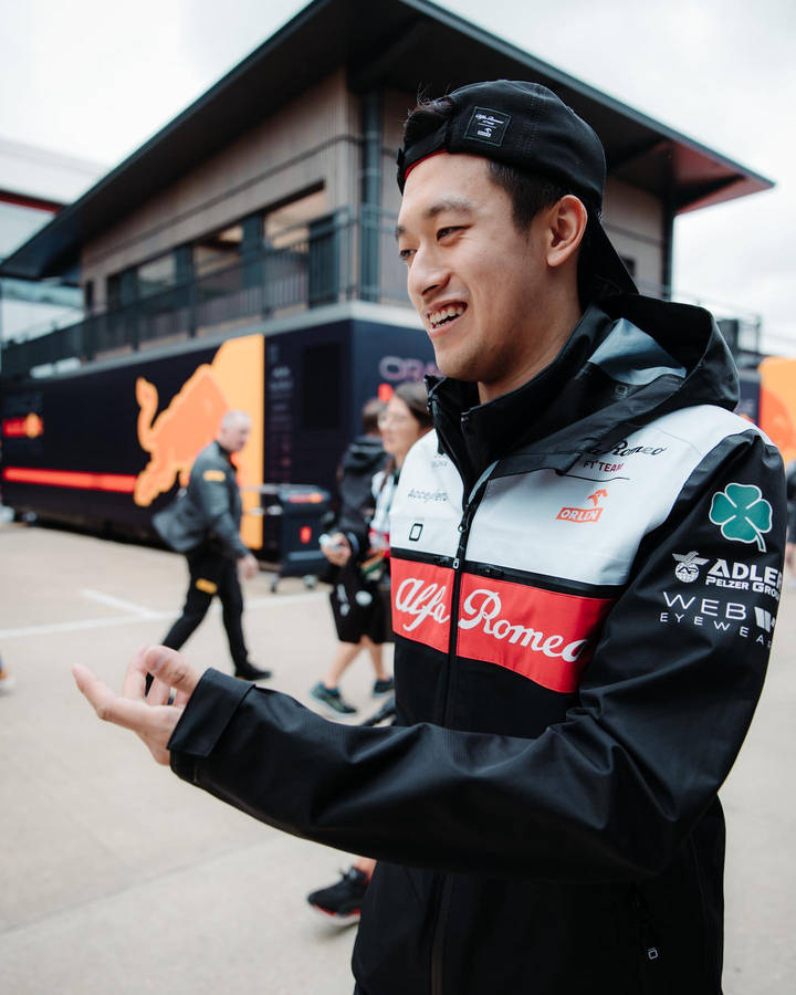 Guanyu Zhou Wearing Jacket With Sponsors Wallpaper