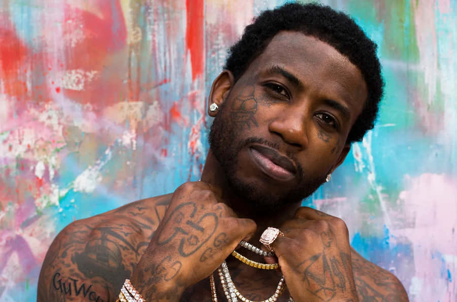 Gucci Mane Portrait Against Colorful Backdrop Wallpaper