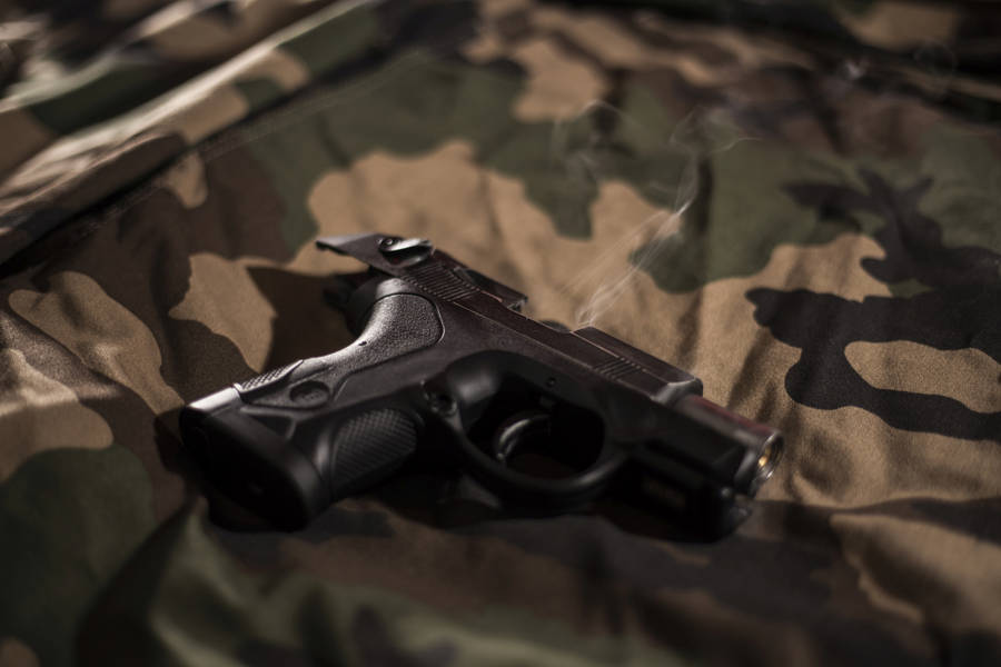 Gun On Camouflage Sheet Wallpaper