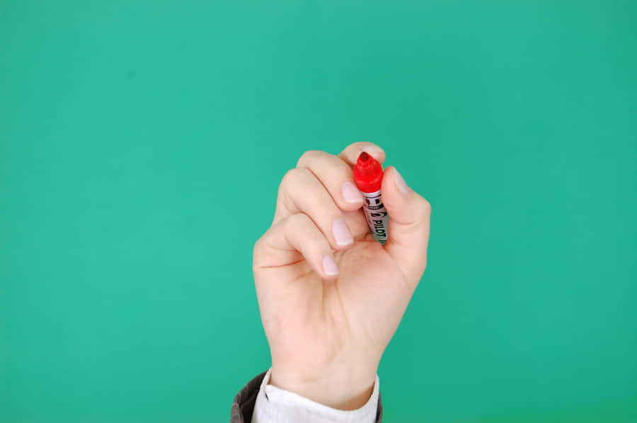 Hand Holding Red Permanent Marker Wallpaper