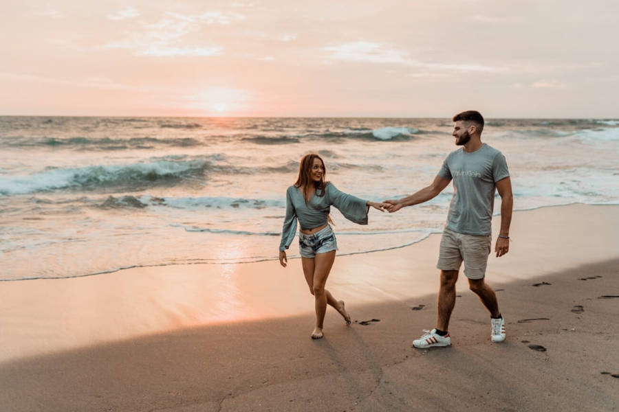 Hand In Hand Couple On Beach Wallpaper