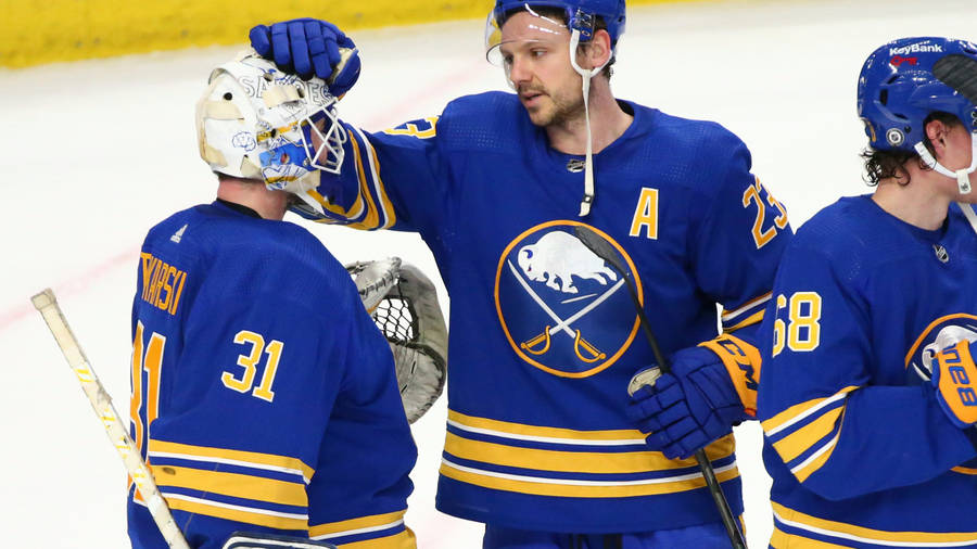 Handsome Canadian Ice Hockey Player Sam Reinhart With Teammates Wallpaper