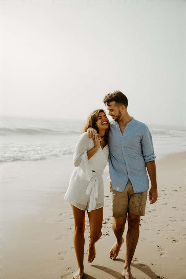 Happy Couple At Beach Close Together Wallpaper