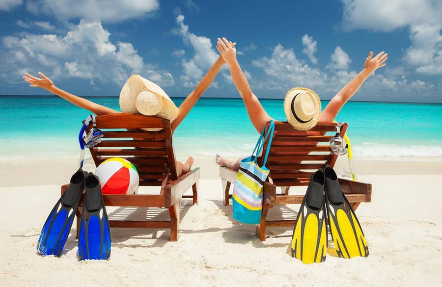 Happy Couple Enjoying Beach Vacation Wallpaper