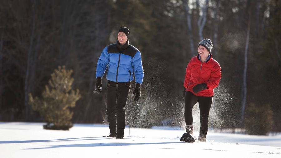 Happy Couple Snowshoeing Wallpaper