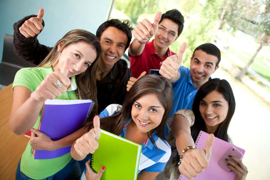 Happy Students Giving Thumbs Up Wallpaper