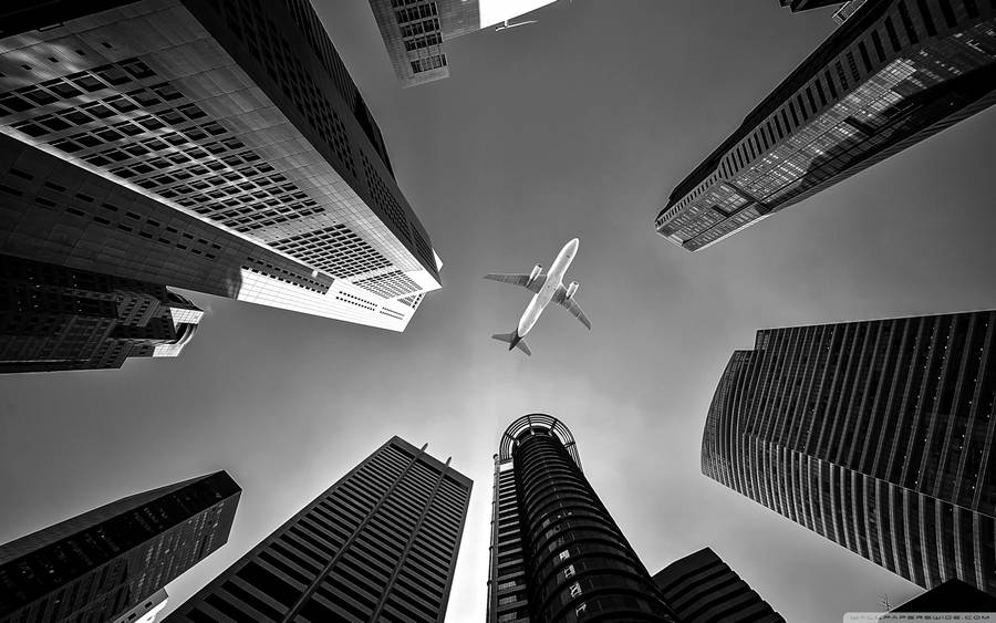 Hd Plane Flying Over Skyscrapers Wallpaper