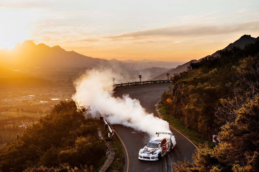 High Speed Drifting Adventure On A Mountain Road Wallpaper