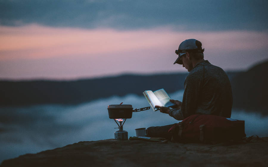 Hiker Reading Book In Mountain Wallpaper