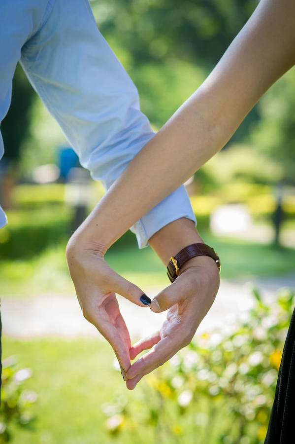 Holding Hands Forming A Heart Wallpaper