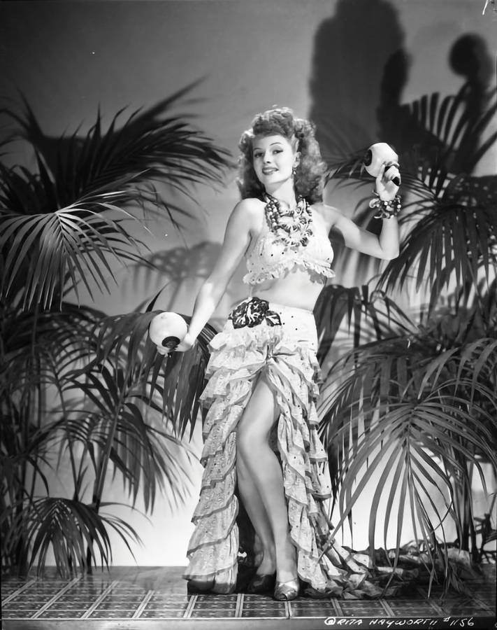 Hollywood Icon Rita Hayworth Dancing With Maracas Wallpaper