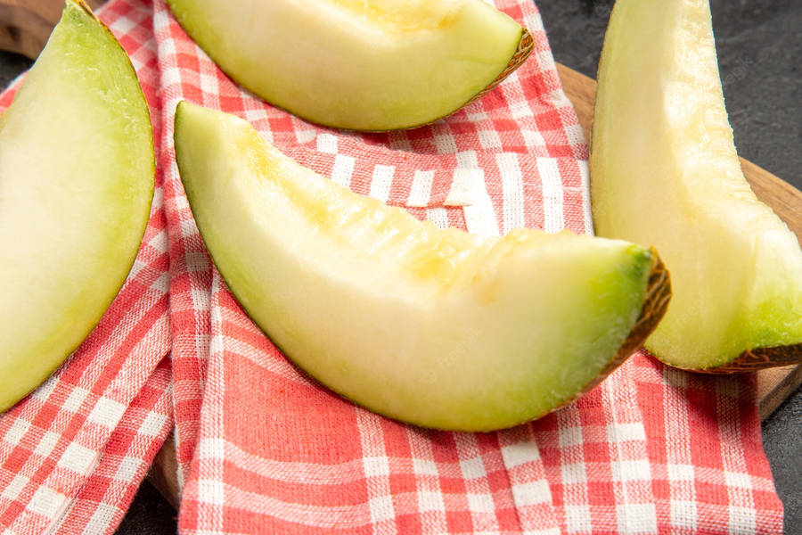 Honeydew Melon Slices On Red Blankets Wallpaper