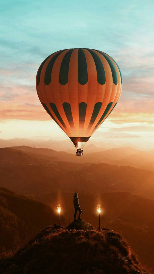 Hot Air Balloon Man On Rock Wallpaper