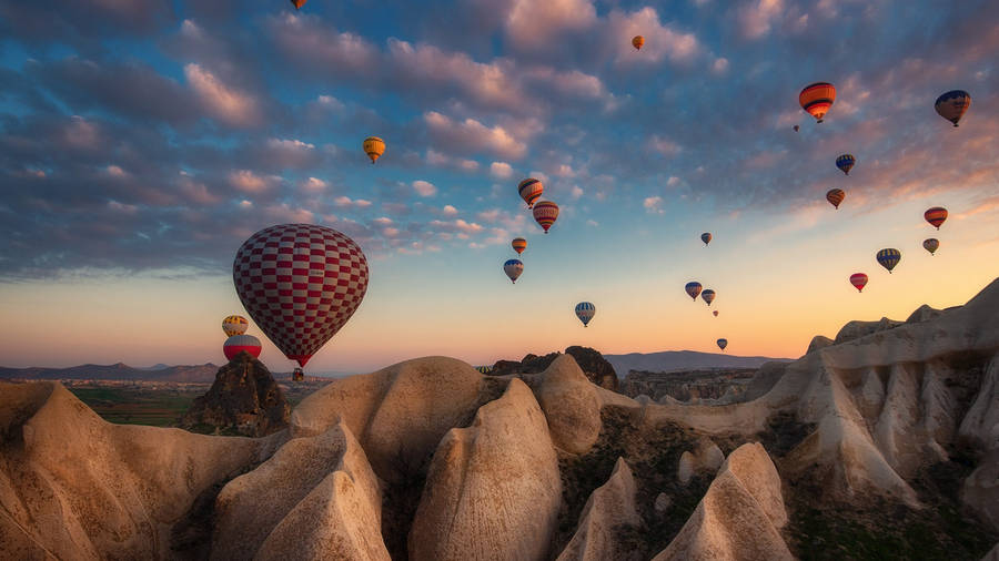 Hot Air Balloon Over Rock Mountains Wallpaper