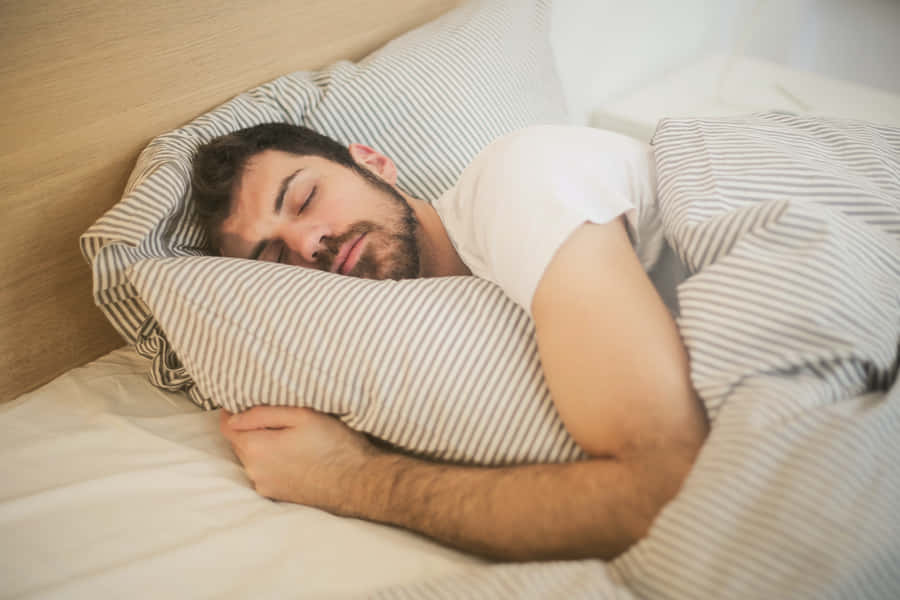 Hugging A Pillow While Sleeping Wallpaper