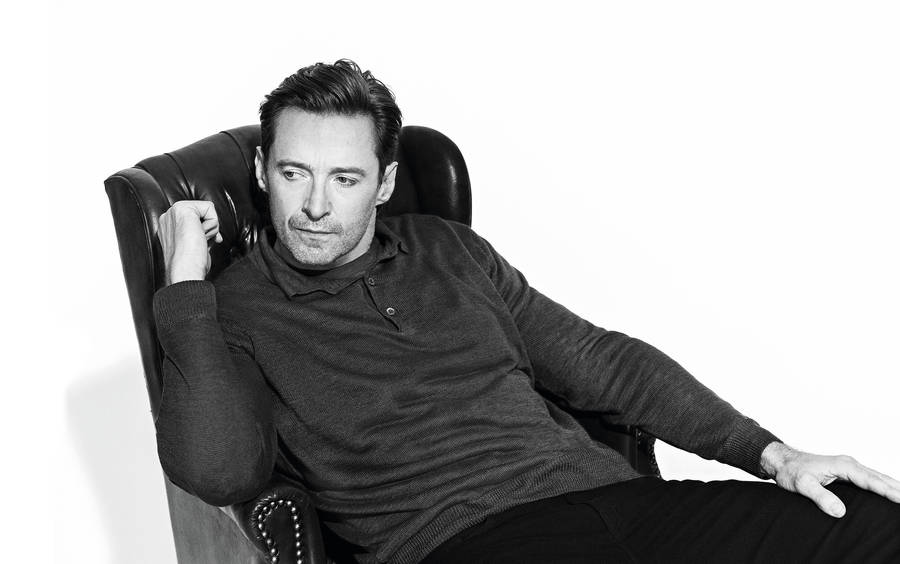 Hugh Jackman On Chair Grayscale Wallpaper