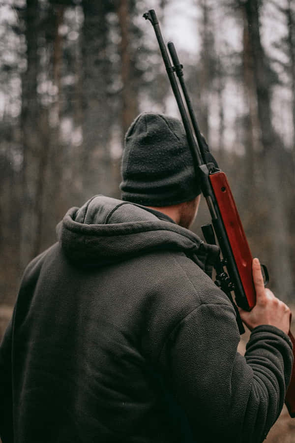 Hunterin Woodswith Rifle Wallpaper