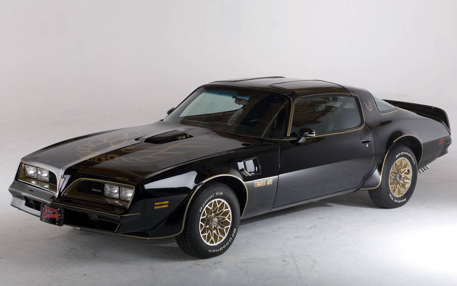 Iconic 1977 Pontiac Firebird Against A Scenic Backdrop Wallpaper