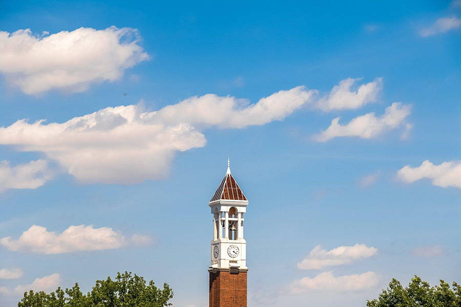 Iconic Bell Tower At Purdue University Under A Cloudy Sky Wallpaper