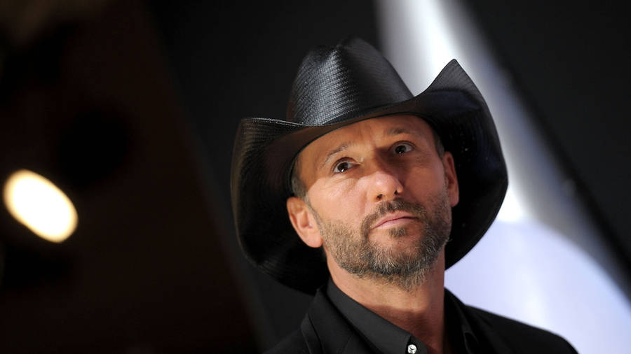 Iconic Country Star Tim Mcgraw Illuminated By Spotlights Wallpaper