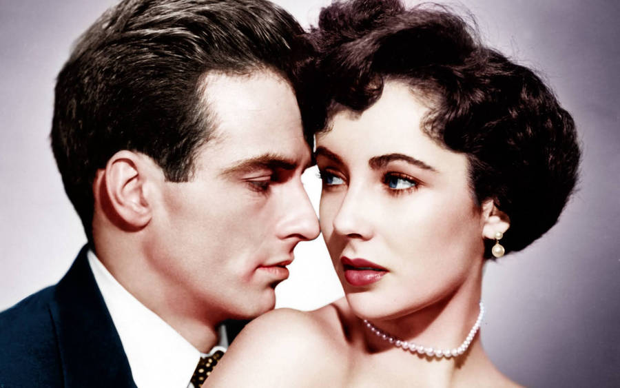 Iconic Hollywood Stars Montgomery Clift And Elizabeth Taylor In Deep Conversation Wallpaper