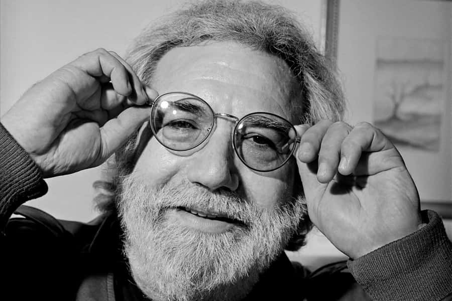 Iconic_ Musician_ Jerry_ Garcia_ Adjusting_ Glasses Wallpaper