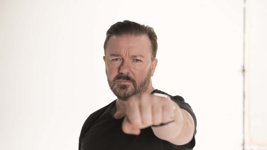 Iconic Stand-up Comedian Ricky Gervais In An Intimate Moment Wallpaper