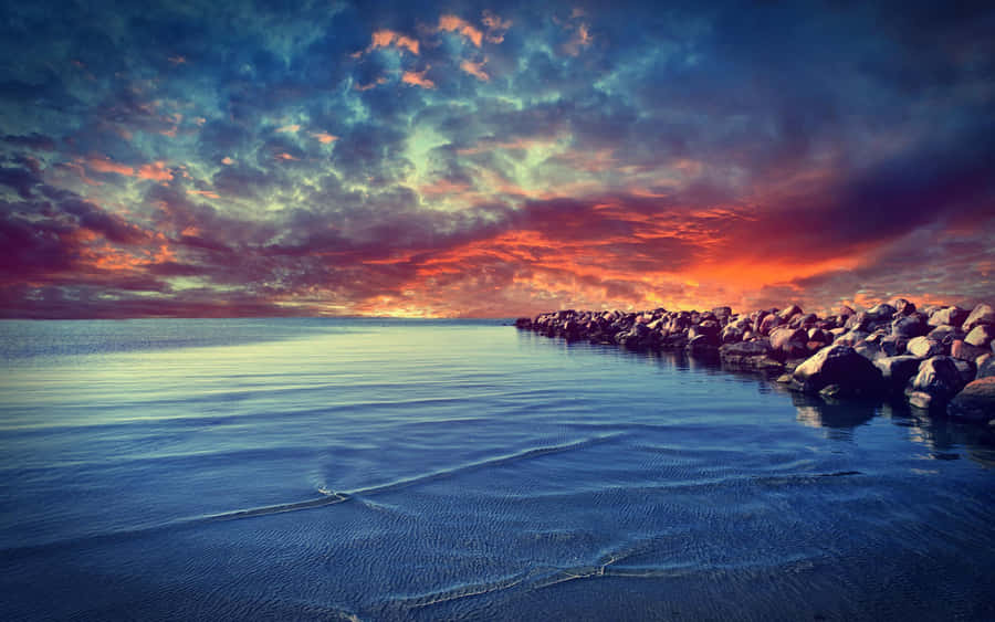 Image A Calm Beach Scene Reflected On A Tranquil Lake In Northern California. Wallpaper