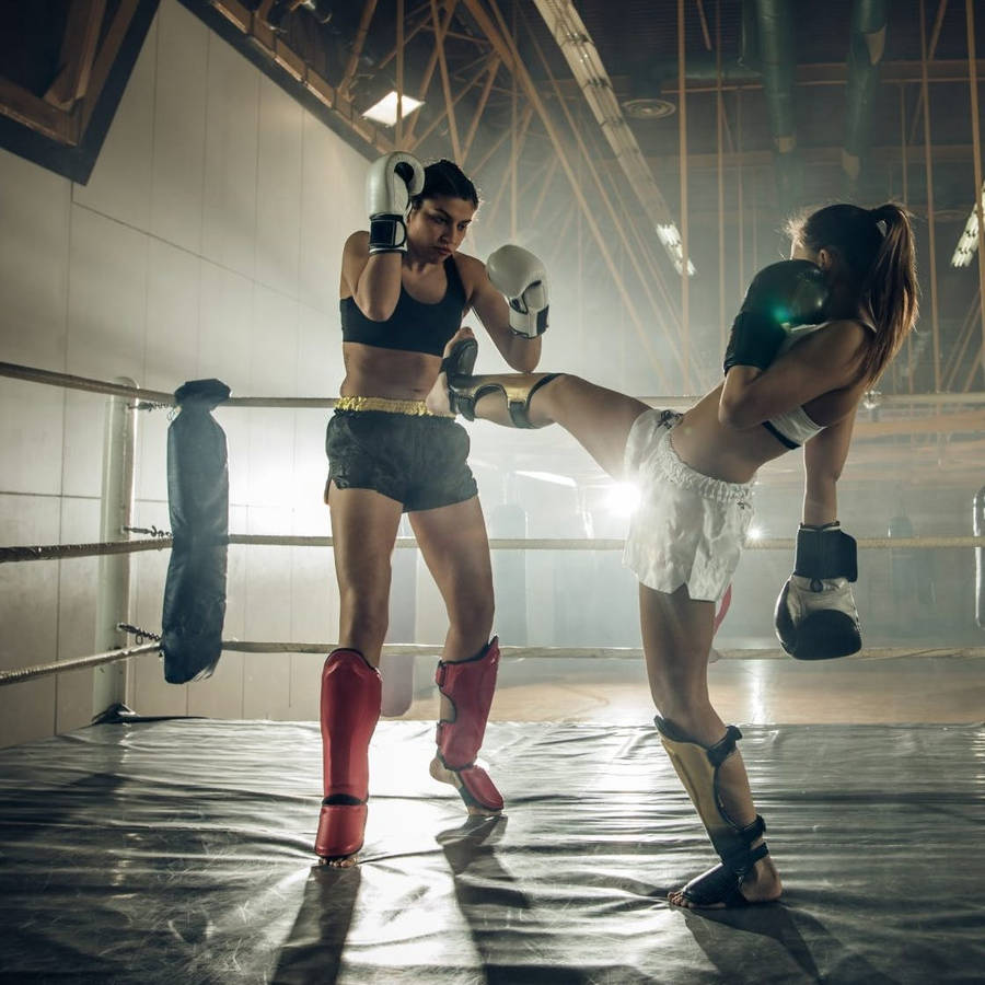 Intense Kickboxing Sparring Session Among Two Female Athletes Intense Kickboxing Sparring Session Among Two Female Athletes