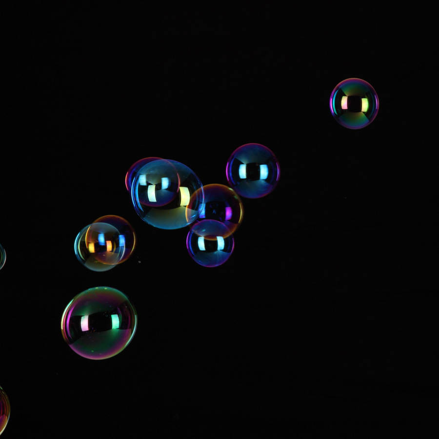 Ipad Pro Floating Bubbles On Black Wallpaper
