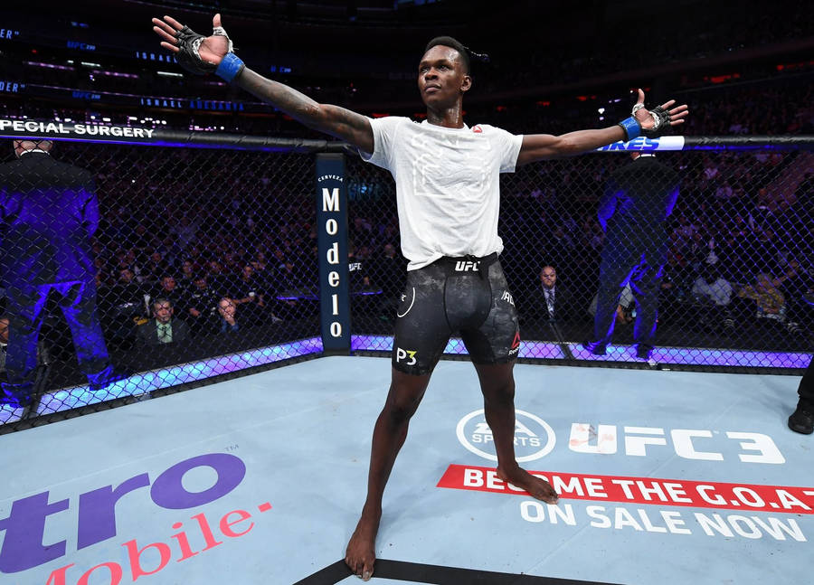 Israel Adesanya Arms Spread In Cage Wallpaper