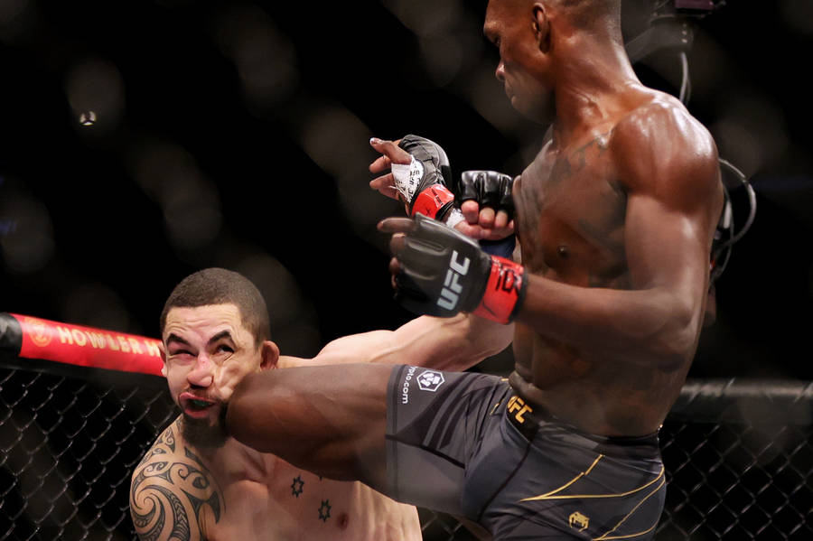 Israel Adesanya Knee On Robert Whittaker Face Wallpaper