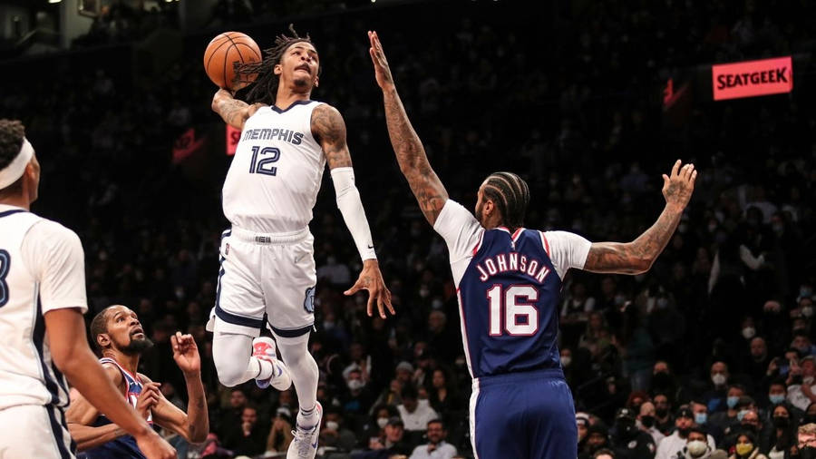 Ja Morant Soaring High Over Johnson With An Electrifying Dunk Wallpaper