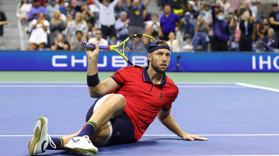 Jack Sock Sitting On Tennis Court Wallpaper