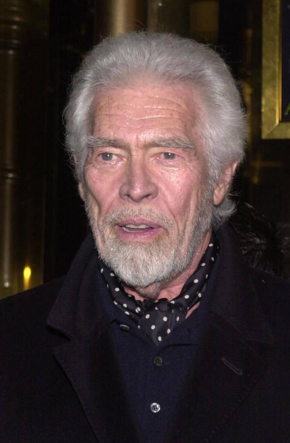 James Coburn Wearing A Scarf Wallpaper