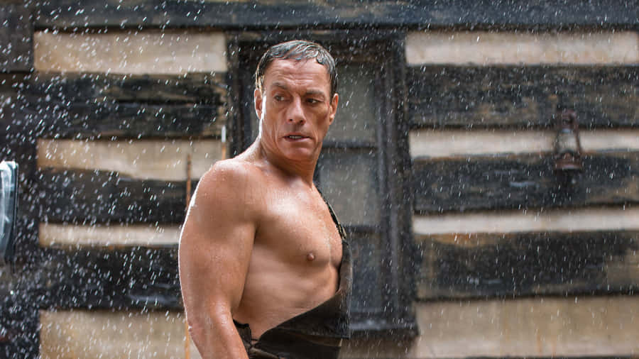 Jean Claude Van Damme Flexing His Muscled Stance Wallpaper