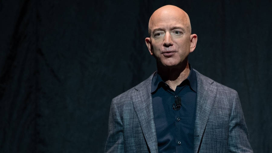 Jeff Bezos In Plain Black Background Wallpaper