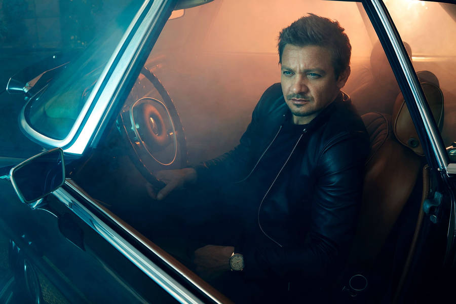 Jeremy Renner Driver's Seat Wallpaper