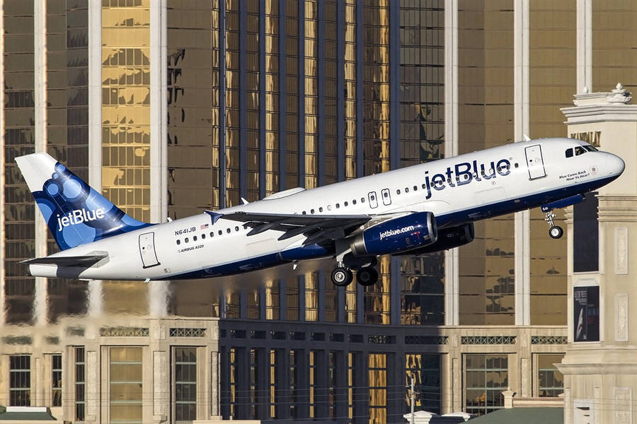 Jetblue Airplane By City Buildings Wallpaper