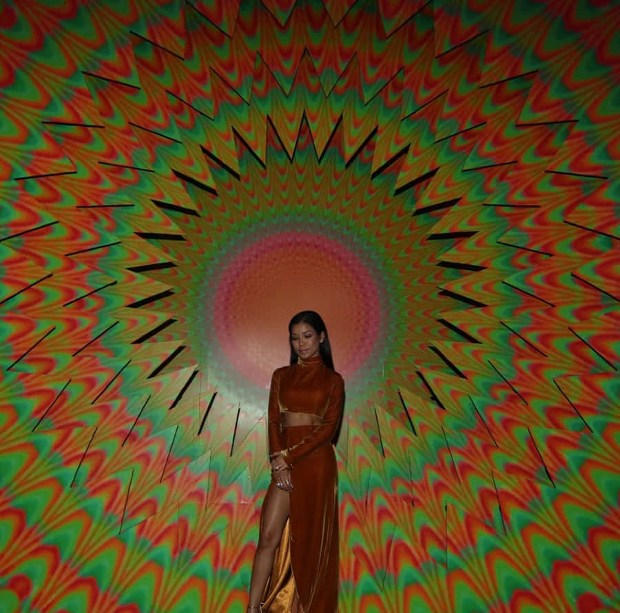 Jhene Aiko Posing Artistically In Colorful Dress Wallpaper