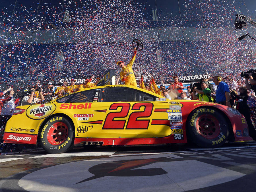 Joey Logano Celebrating His Victory With Confetti At The Race Track Wallpaper