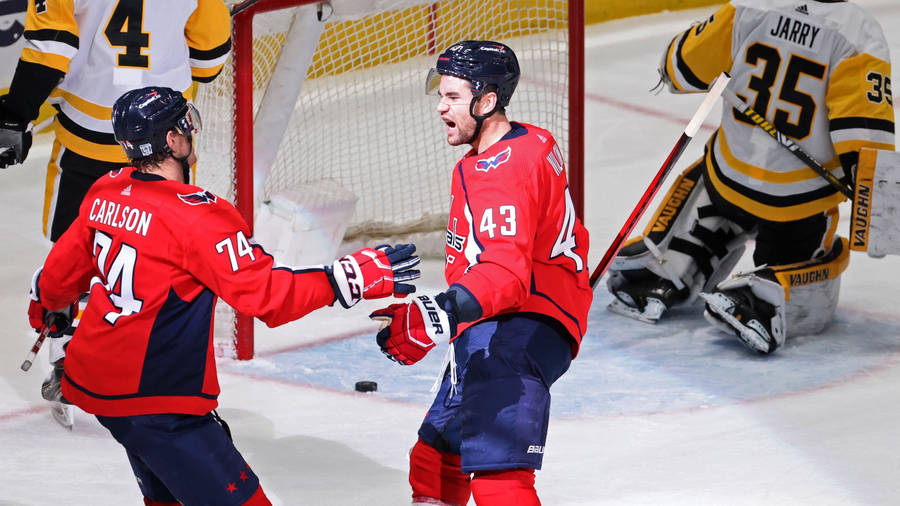 John Carlson Of The Washington Capitals In Action Against The Boston Bruins Wallpaper