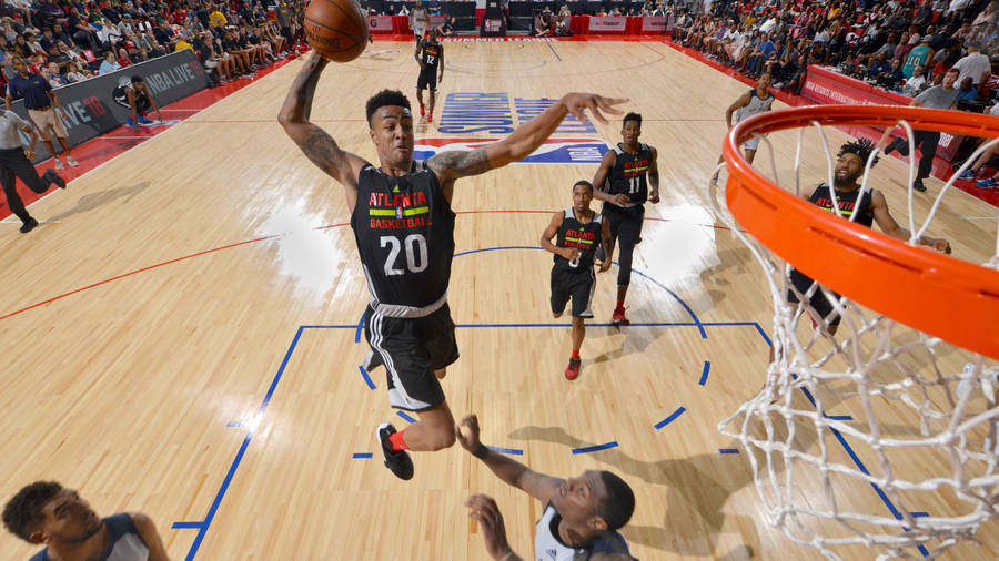 John Collins While Jumping With Ball Wallpaper